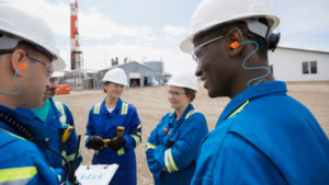 Workers discussing condition-based maintenance findings.