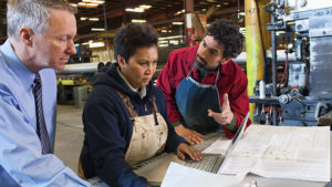 Three maintenance workers discussing