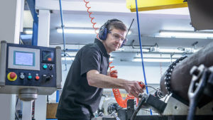 Maintenance worker inspecting machine