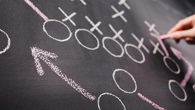 Football play on chalkboard