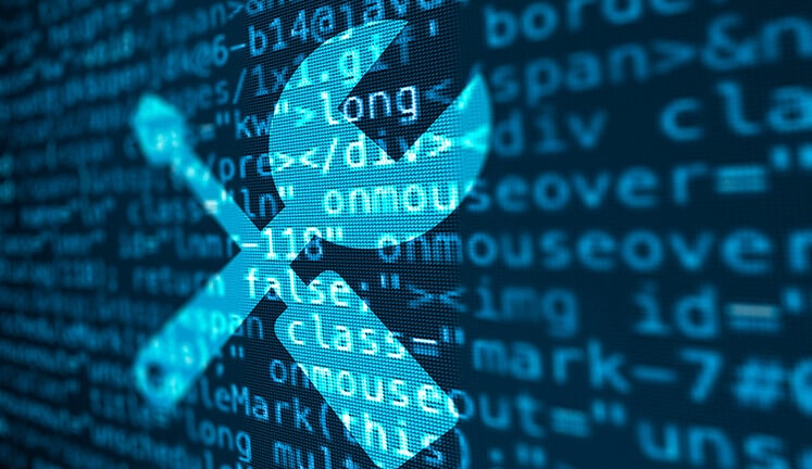 Wrench and screwdriver icons over computer code