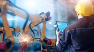 Worker using tablet in digital factory