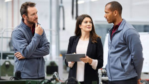 Workers consulting around tablet