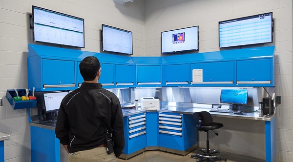 man in black coat looks at data dashboards