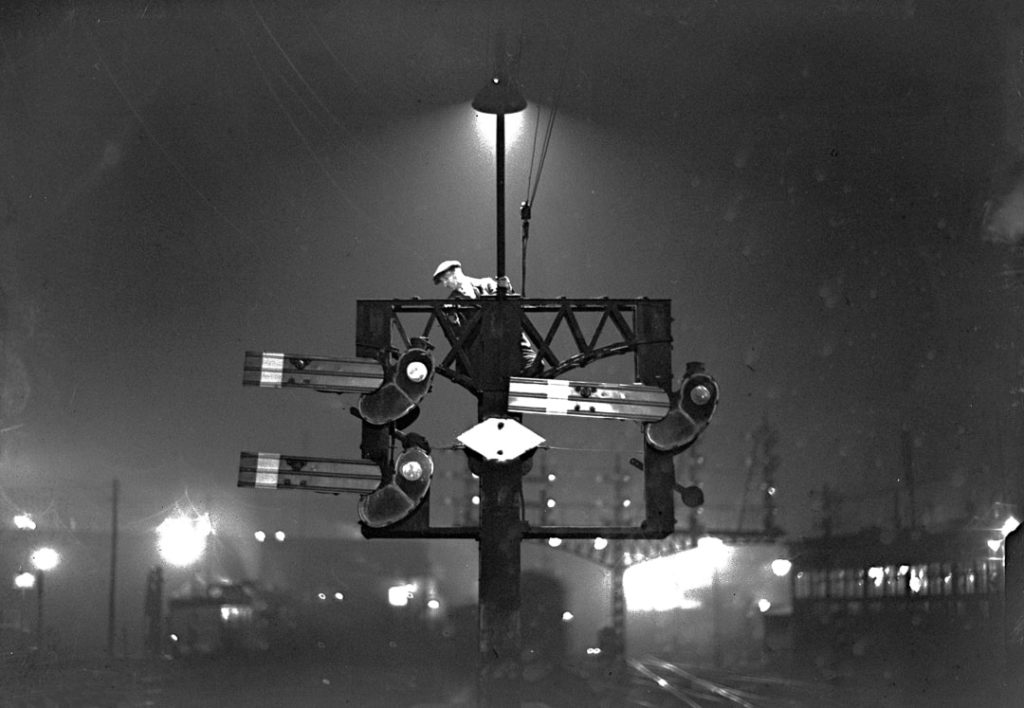 A black and white photo of a railway maintenance worker